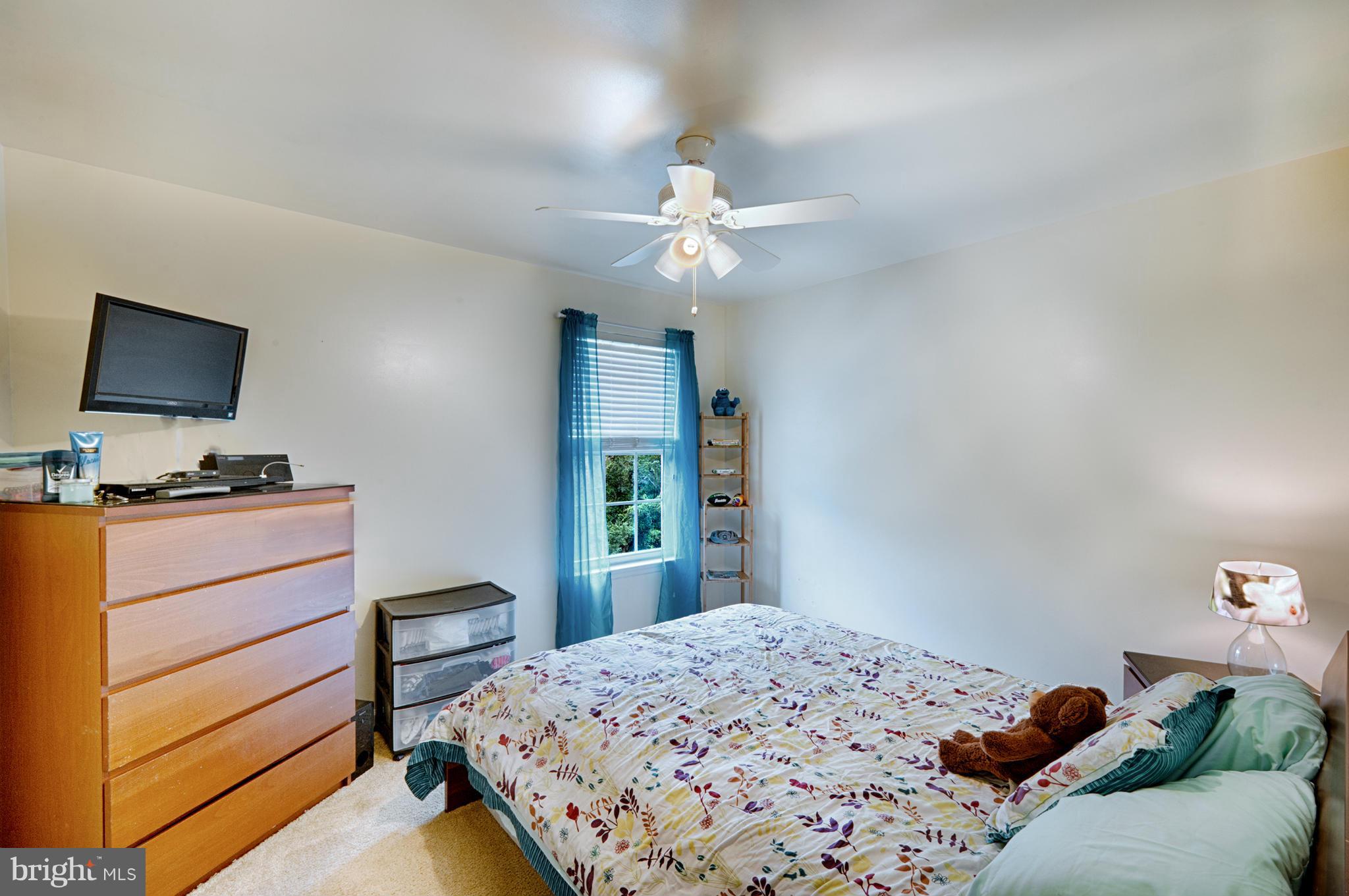 59 Haverhill Road Joppa, MD 21085 - Photo 19 of 28 a bedroom with a bed and a flat tv screen on dresser