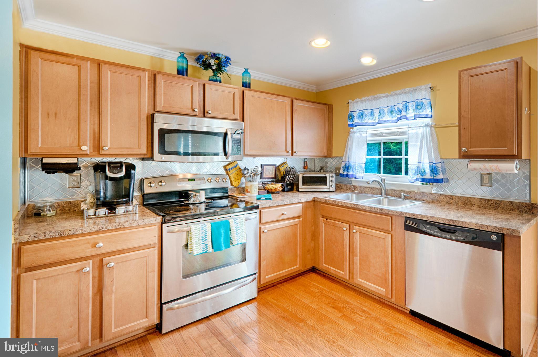 59 Haverhill Road Joppa, MD 21085 - Photo 10 of 28 a kitchen with granite countertop white cabinets and white appliances