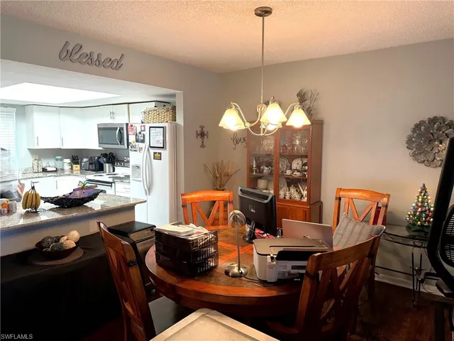 a view of a dining room with furniture and chandelier