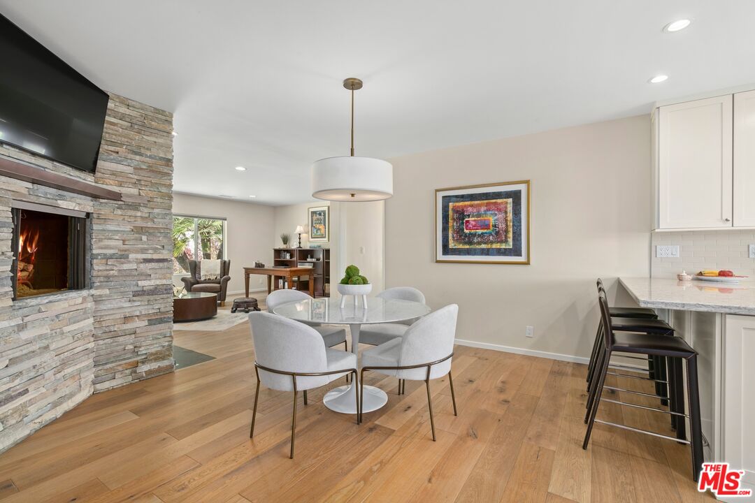 6523 Lakeridge Road Los Angeles, CA 90068 - Photo 12 of 28 a view of a dining room with furniture wooden floor and a fireplace