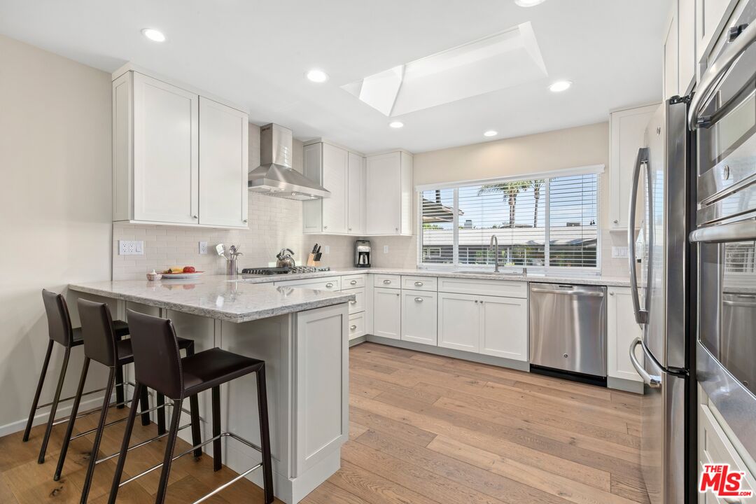 6523 Lakeridge Road Los Angeles, CA 90068 - Photo 13 of 28 a kitchen with a sink stainless steel appliances and white cabinets