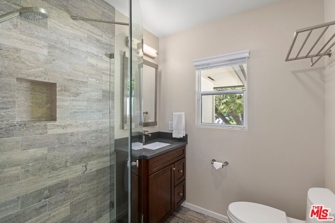 6523 Lakeridge Road Los Angeles, CA 90068 - Photo 22 of 28 a bathroom with a granite countertop toilet and a sink