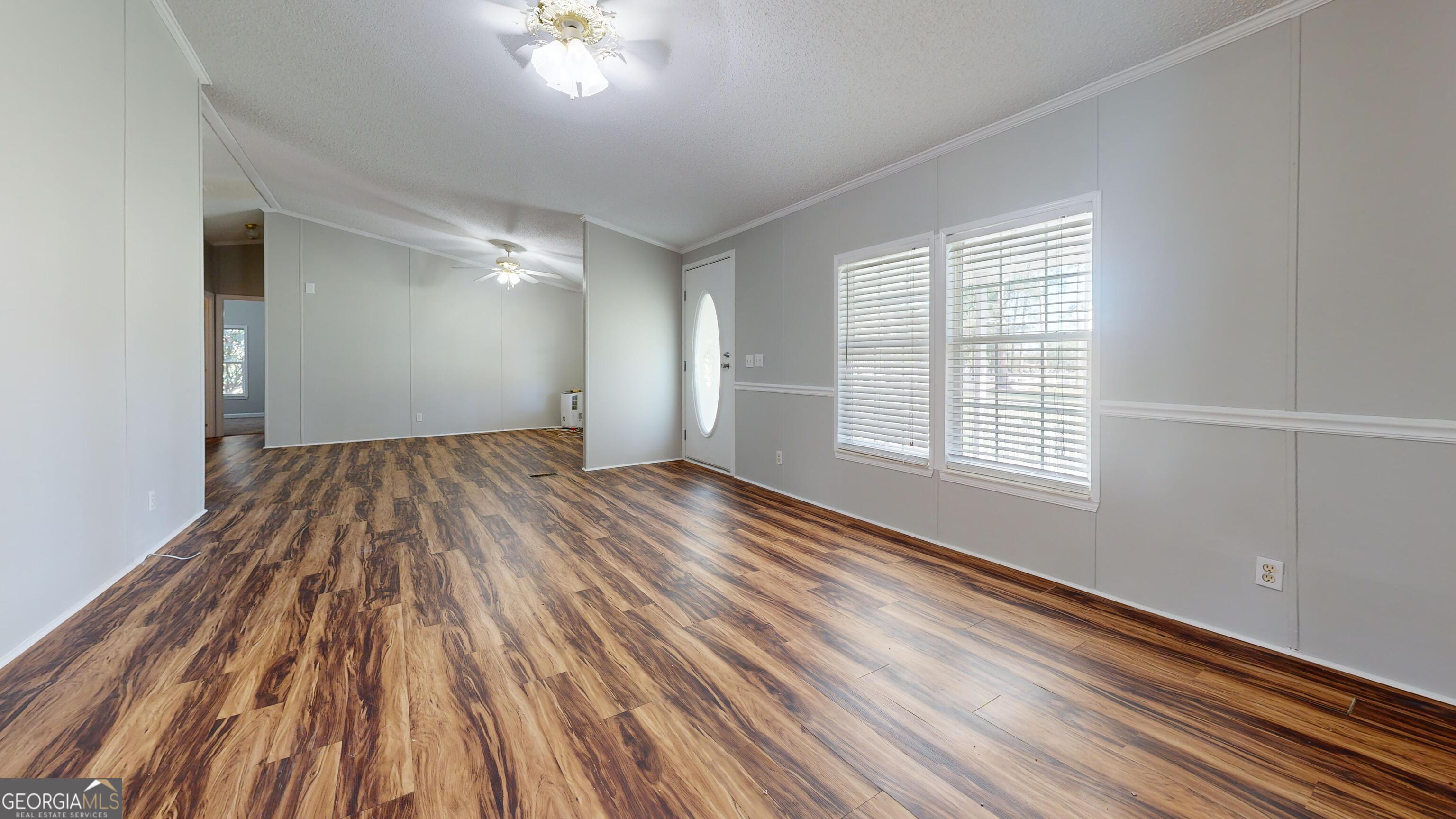 6498 Central Avenue Waycross, GA 31503 - Photo 8 of 20 wooden floor in an empty room with a window