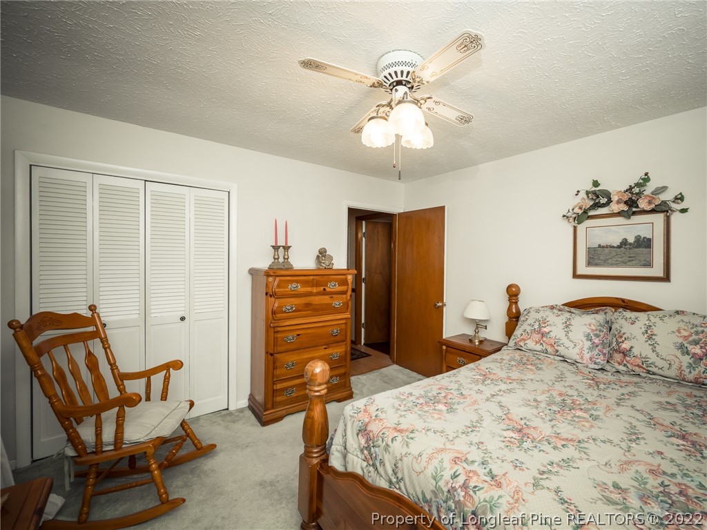156 Pinewood Road Lumberton, NC 28358 - Photo 28 of 50 a bedroom with a bed and chair