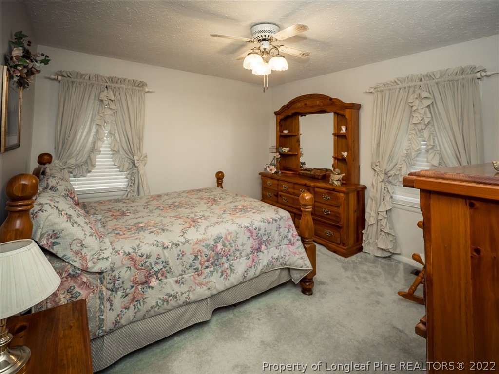 156 Pinewood Road Lumberton, NC 28358 - Photo 29 of 50 a bedroom with a bed and a dresser with the mirror