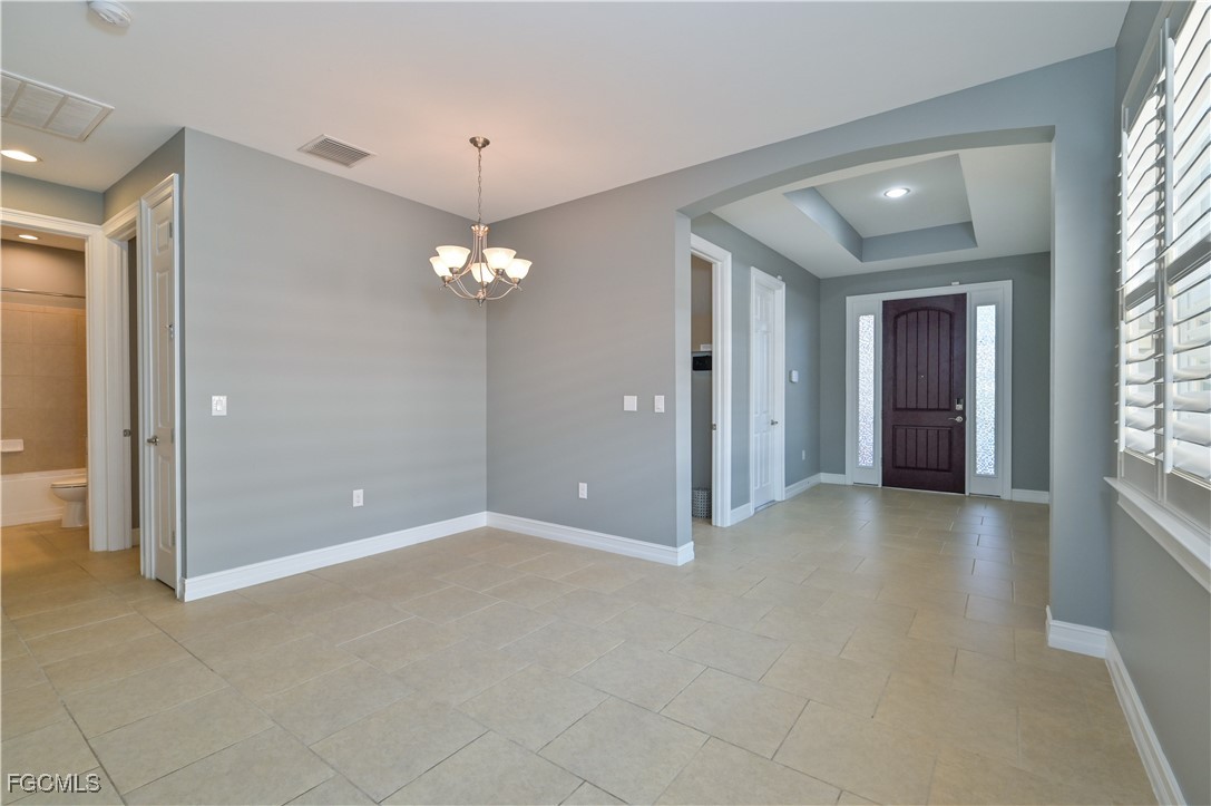 3571 Brittons Court Fort Myers, FL 33916 - Photo 14 of 42 a view of a chandelier in big room and windows