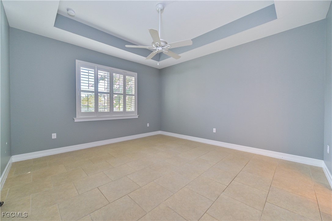 3571 Brittons Court Fort Myers, FL 33916 - Photo 18 of 42 an empty room with windows and chandelier fan