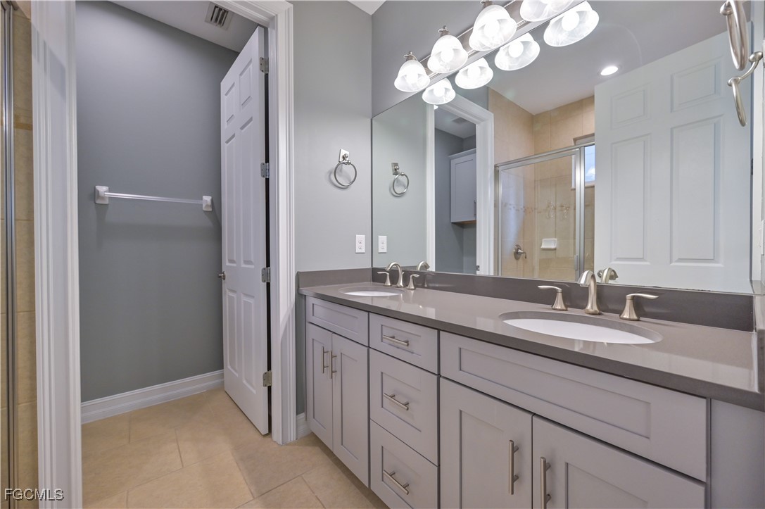 3571 Brittons Court Fort Myers, FL 33916 - Photo 21 of 42 a bathroom with a double vanity sink and a mirror