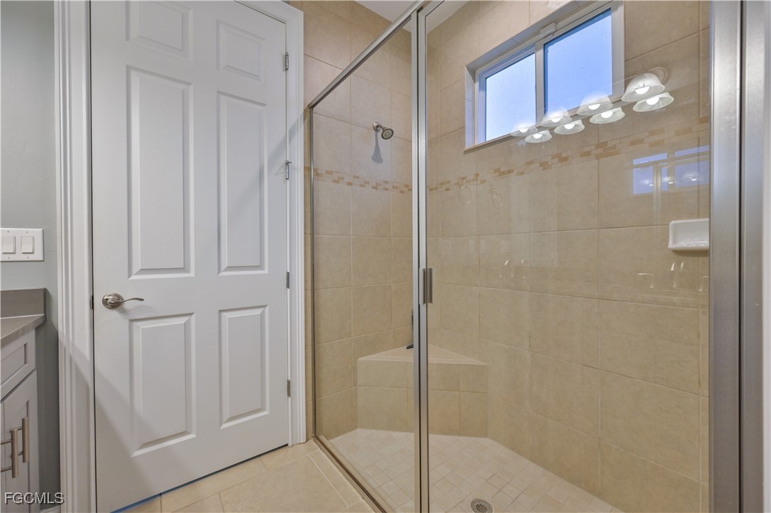 3571 Brittons Court Fort Myers, FL 33916 - Photo 22 of 42 a bathroom with a glass shower door