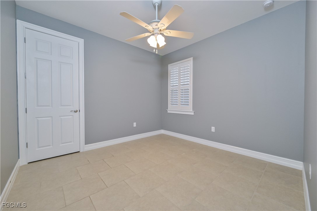 3571 Brittons Court Fort Myers, FL 33916 - Photo 24 of 42 an empty room with windows and ceiling fan