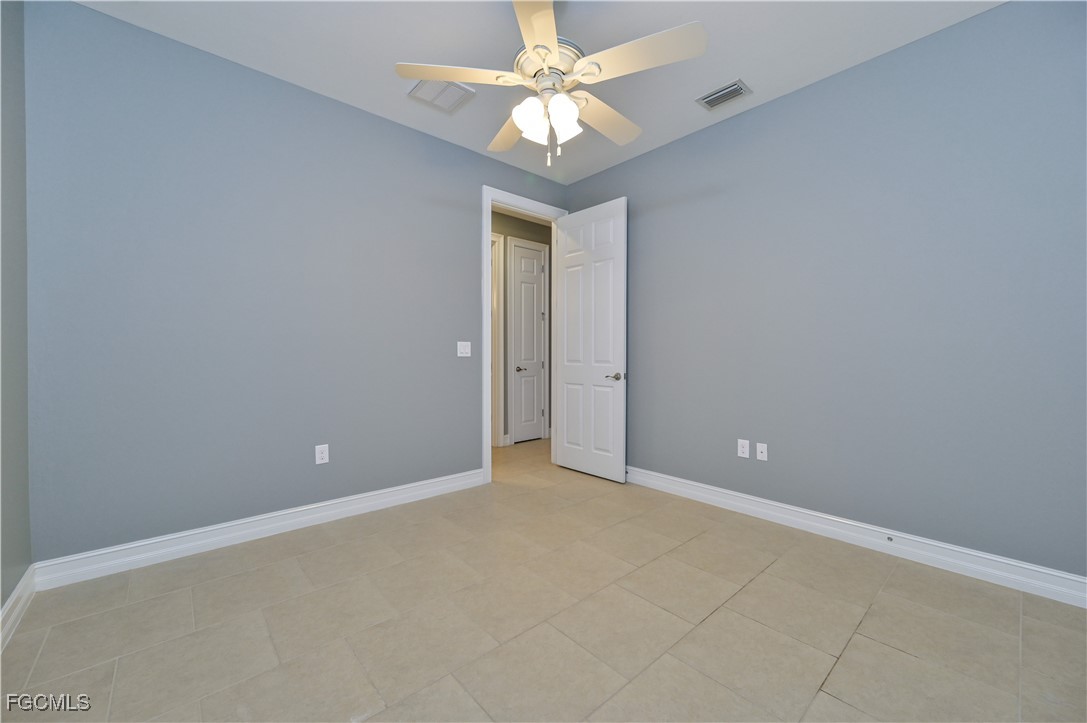 3571 Brittons Court Fort Myers, FL 33916 - Photo 25 of 42 an empty room and chandelier fan