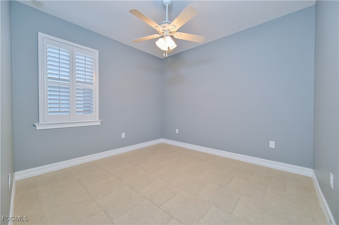 3571 Brittons Court Fort Myers, FL 33916 - Photo 28 of 42 an empty room with a window and a ceiling fan