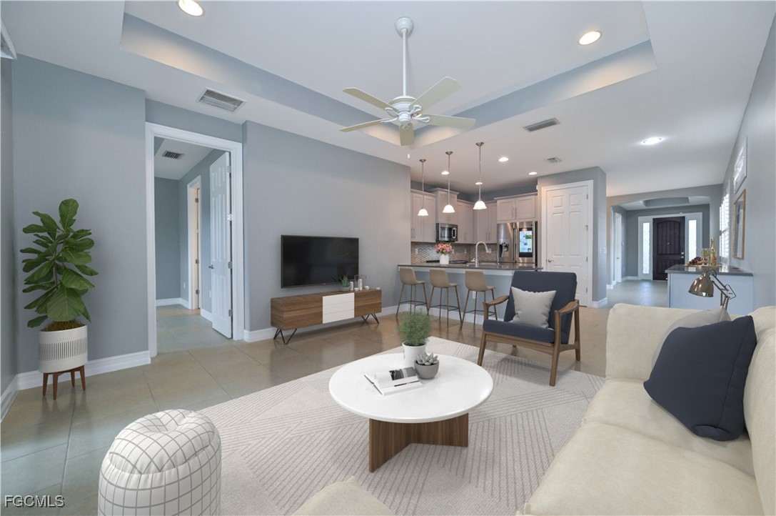 3571 Brittons Court Fort Myers, FL 33916 - Photo 7 of 42 a living room with furniture a dining table and a potted plant