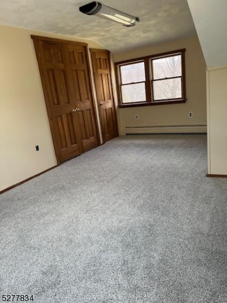 404 Stonetown Road Ringwood, NJ 07456 - Photo 11 of 13 an empty room with windows