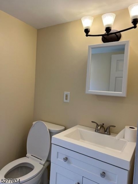 404 Stonetown Road Ringwood, NJ 07456 - Photo 13 of 13 a bathroom with a toilet sink and mirror