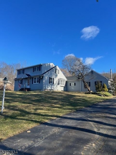 404 Stonetown Road Ringwood, NJ 07456 - Photo 2 of 13 a view of a big house with a big yard