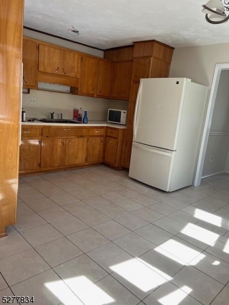 404 Stonetown Road Ringwood, NJ 07456 - Photo 5 of 13 a kitchen with refrigerator and cabinets