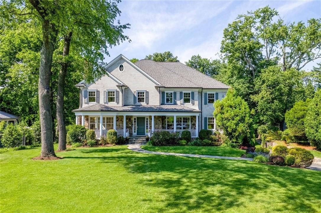 12 Eve Lane Rye, NY 10580 - Photo 1 of 1 a front view of a house with a yard table and chairs