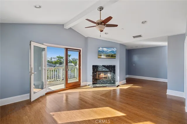 a view of an empty room with a fireplace and a window