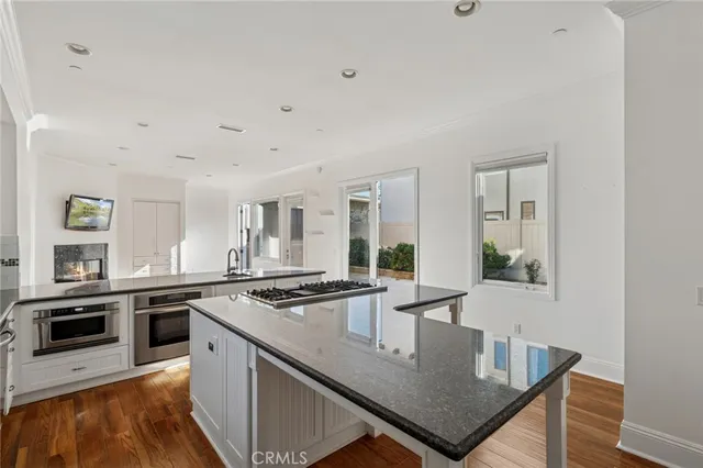 a kitchen with stainless steel appliances granite countertop a stove a sink and a refrigerator