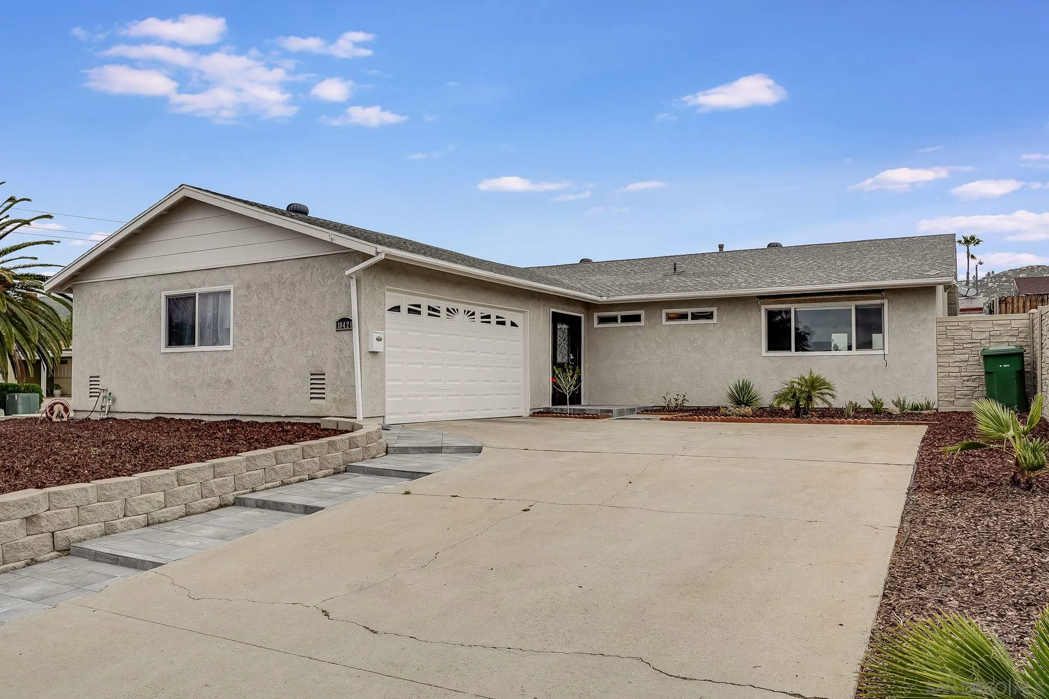 10420 Susie Place Santee, CA 92071 - Photo 2 of 26 a front view of a house with a yard and garage