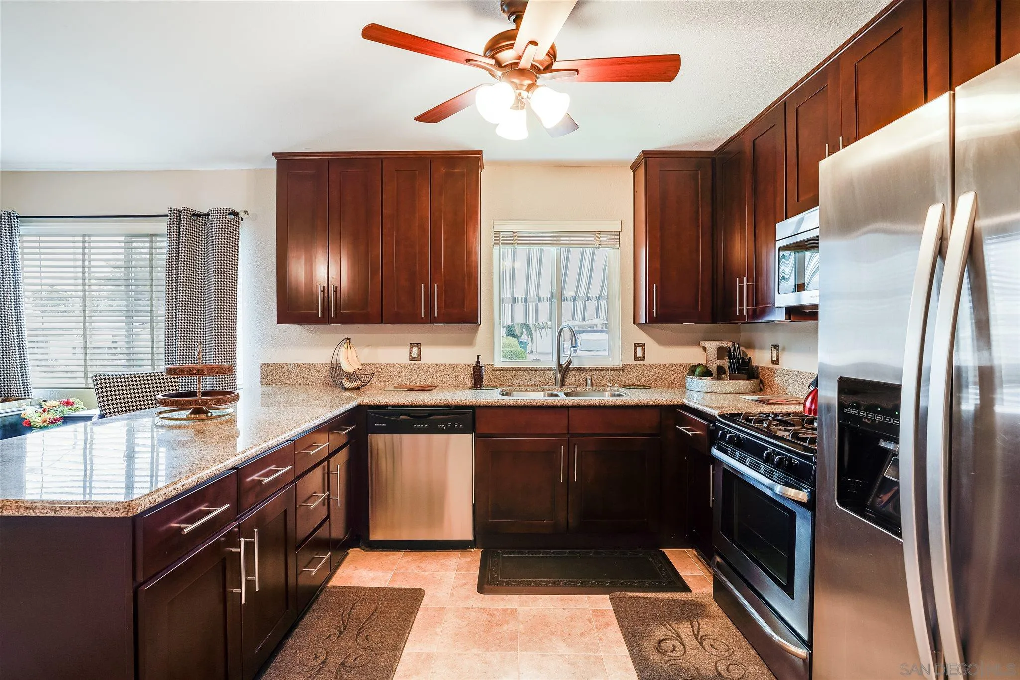 10420 Susie Place Santee, CA 92071 - Photo 5 of 26 a kitchen with stainless steel appliances granite countertop a sink stove and refrigerator