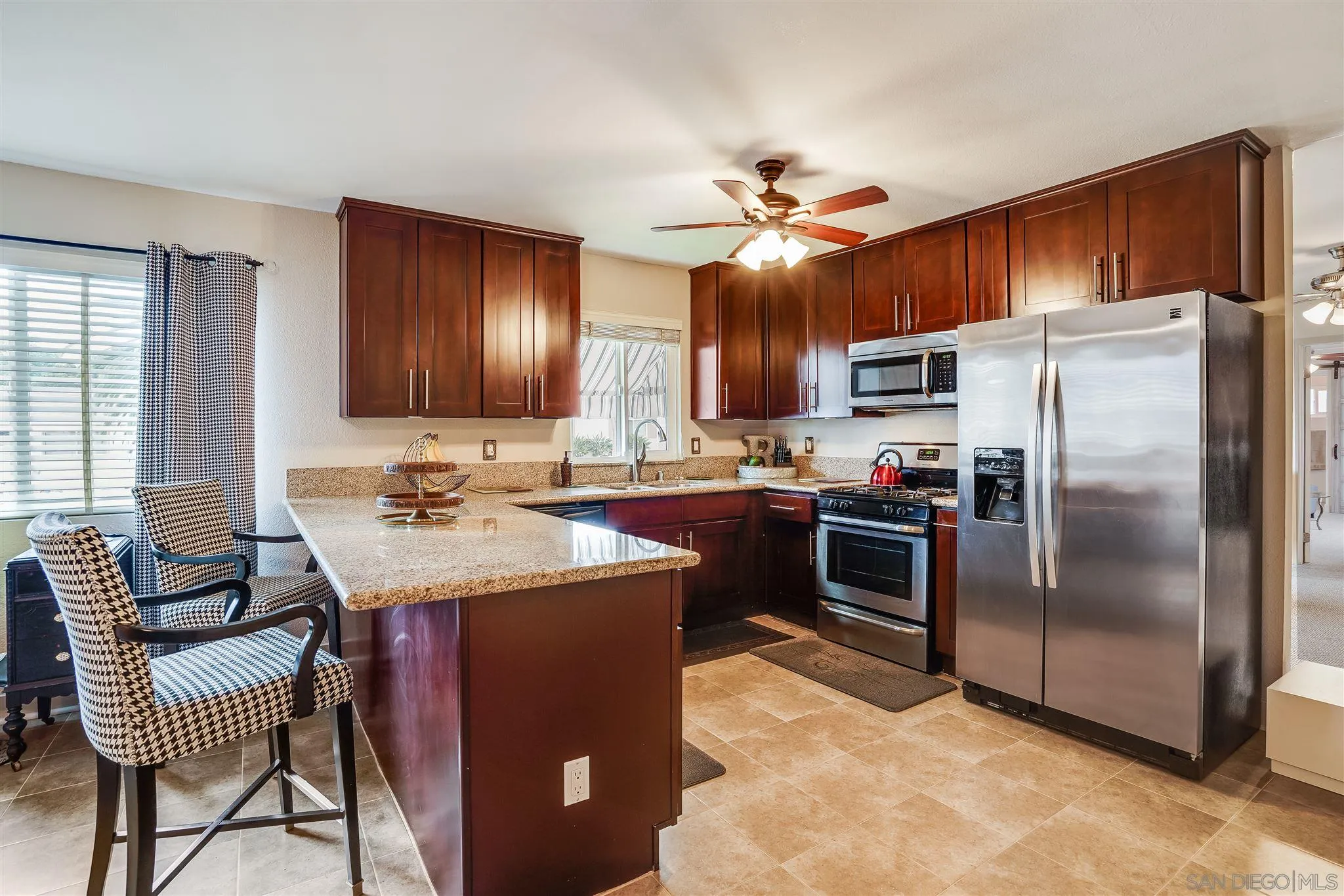 10420 Susie Place Santee, CA 92071 - Photo 6 of 26 a kitchen with kitchen island a counter top space appliances and a center island