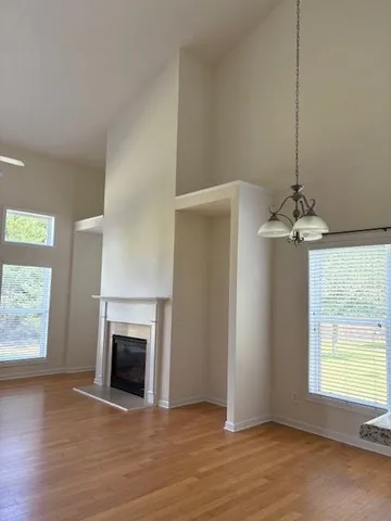 a view of a livingroom with a fireplace and window