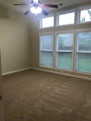 an empty room with a empty space and windows
