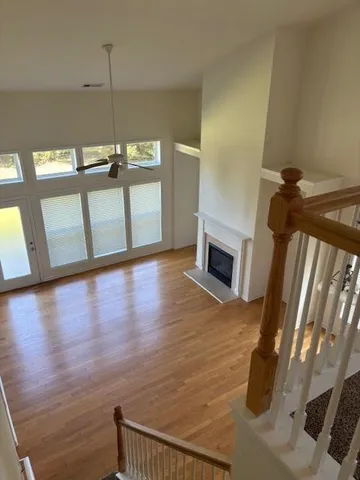 a view of a livingroom with wooden floor and fireplace