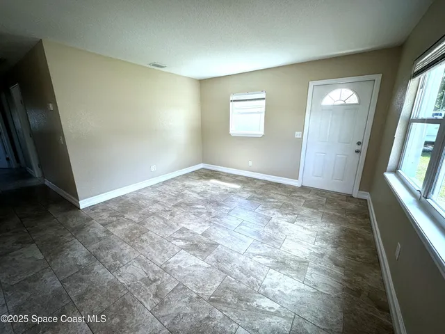 a view of an empty room and window