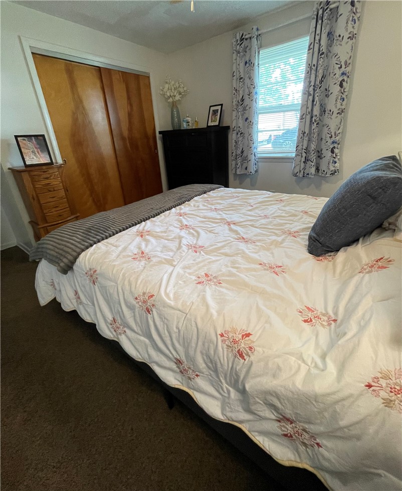 360 Ridge Street Piqua, OH 45356 - Photo 22 of 46 This cozy bedroom features warm wooden closet doors and ample natural light from the window.