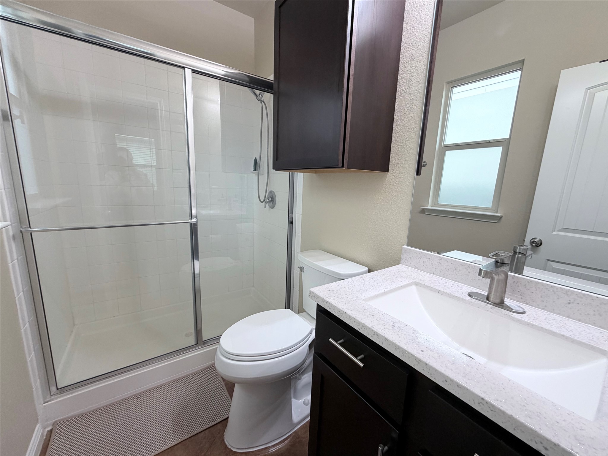 4508 Kind Way, Unit 249 Austin, TX 78725 - Photo 12 of 20 Primary bathroom featuring vanity and a walk in shower.
