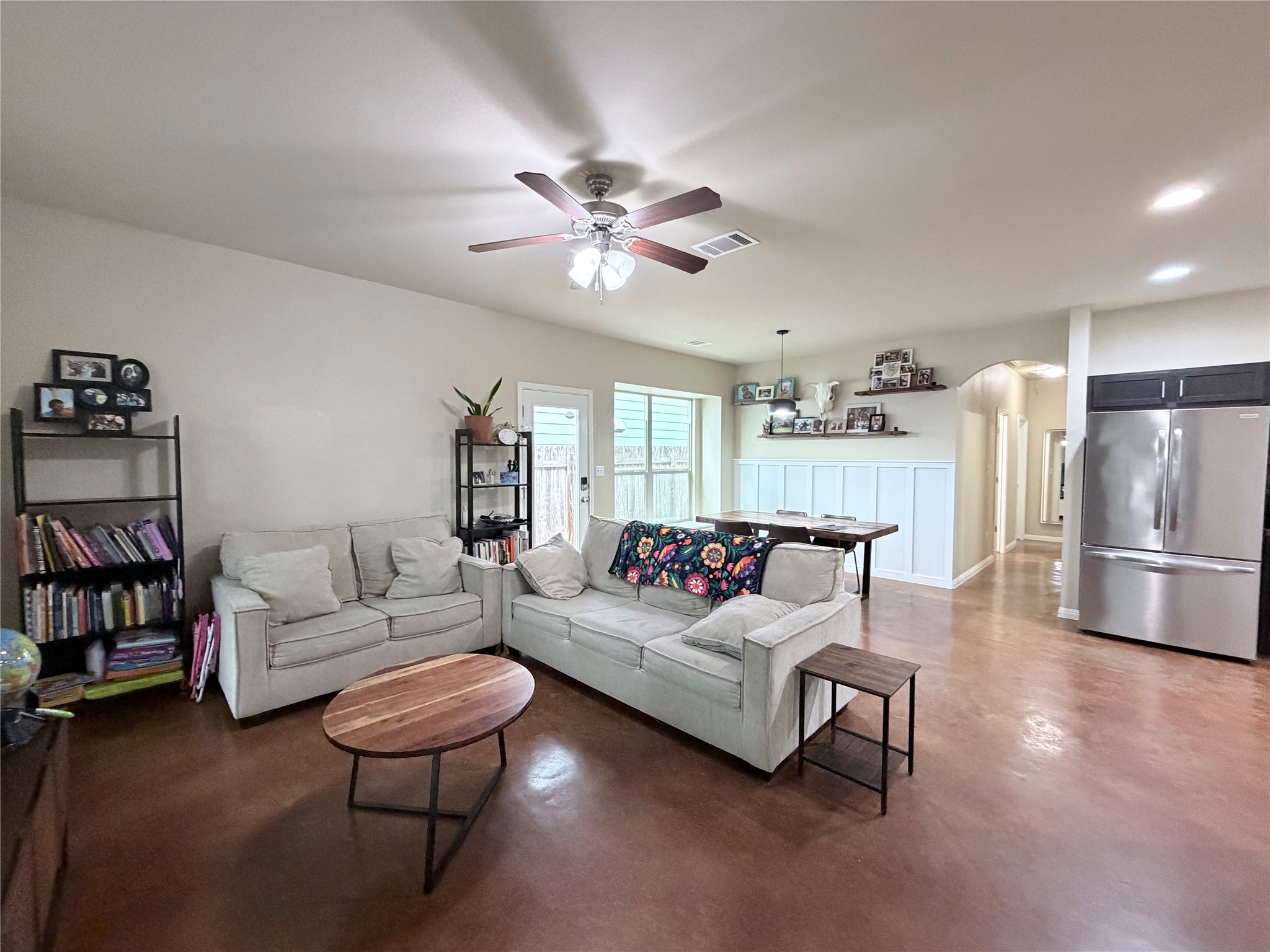 4508 Kind Way, Unit 249 Austin, TX 78725 - Photo 3 of 20 Living room featuring arched walkways, concrete floors, ceiling fan, and recessed lighting.