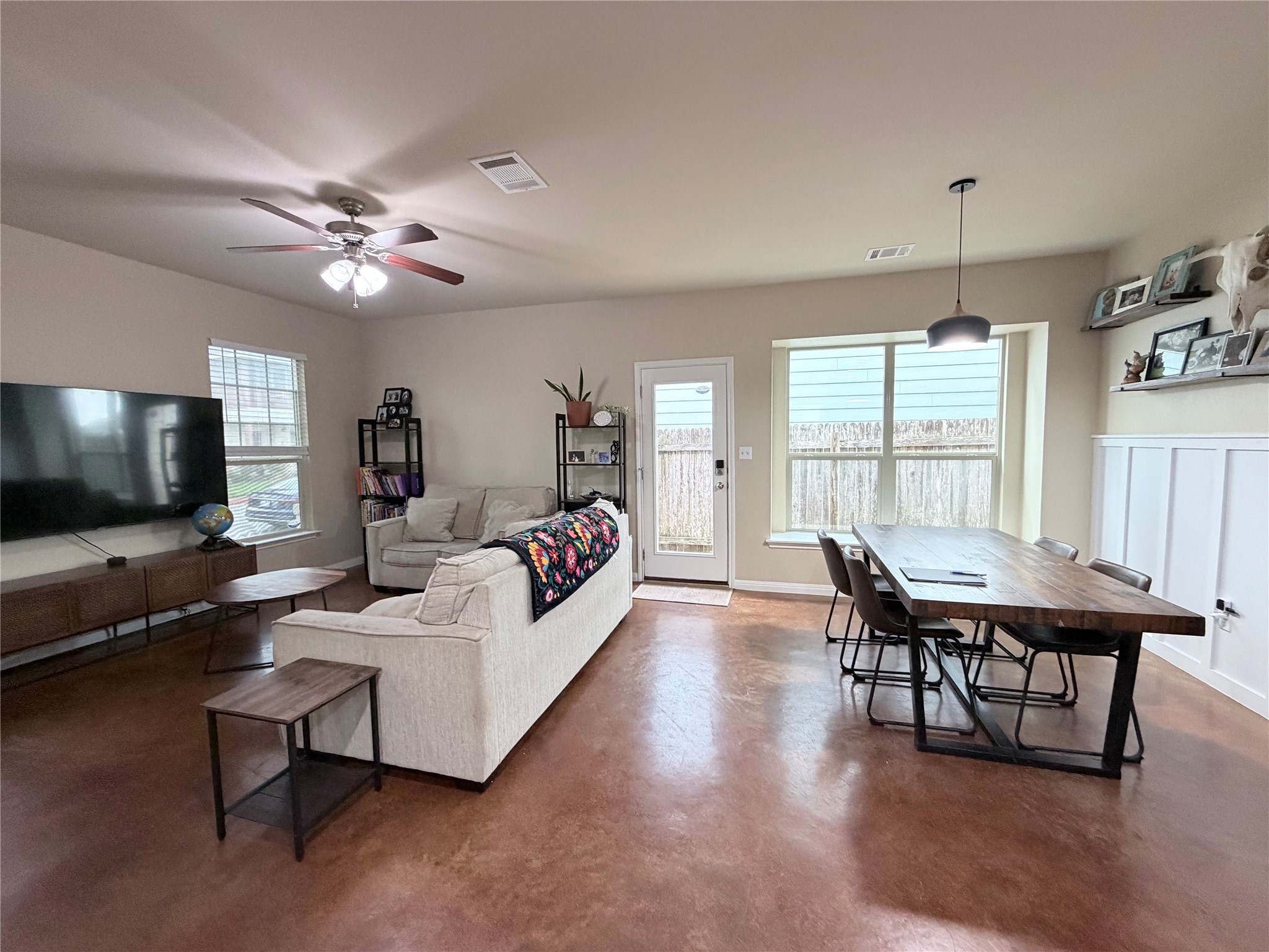 4508 Kind Way, Unit 249 Austin, TX 78725 - Photo 6 of 20 Living area with finished concrete flooring and ceiling fan