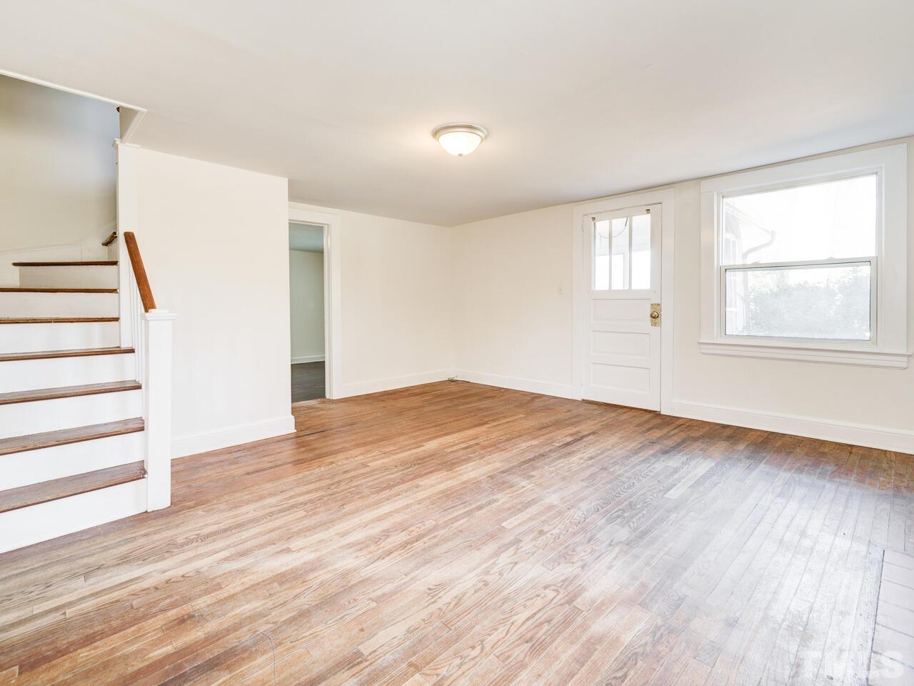 269 Hesters Store Road Roxboro, NC 27574 - Photo 11 of 30 a view of empty room with wooden floor and fan