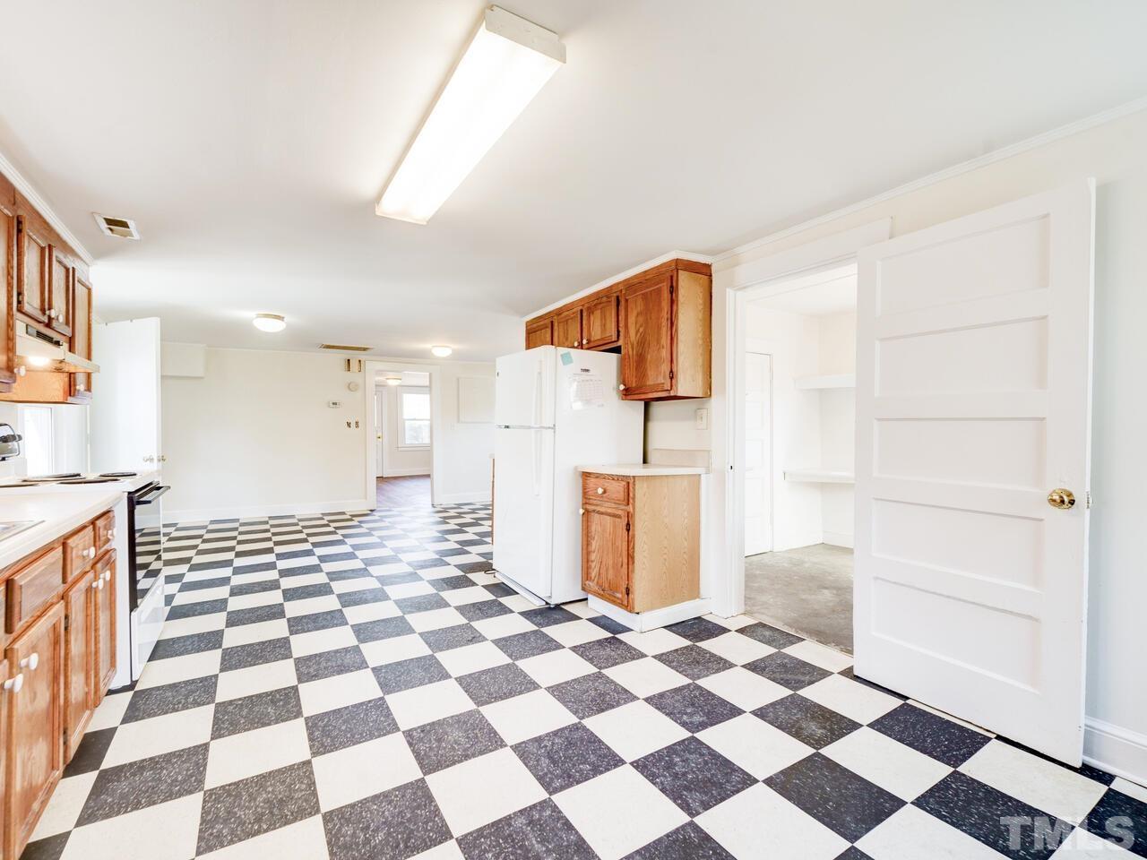 269 Hesters Store Road Roxboro, NC 27574 - Photo 14 of 30 a view of a storage & utility room with a black white checkered floor