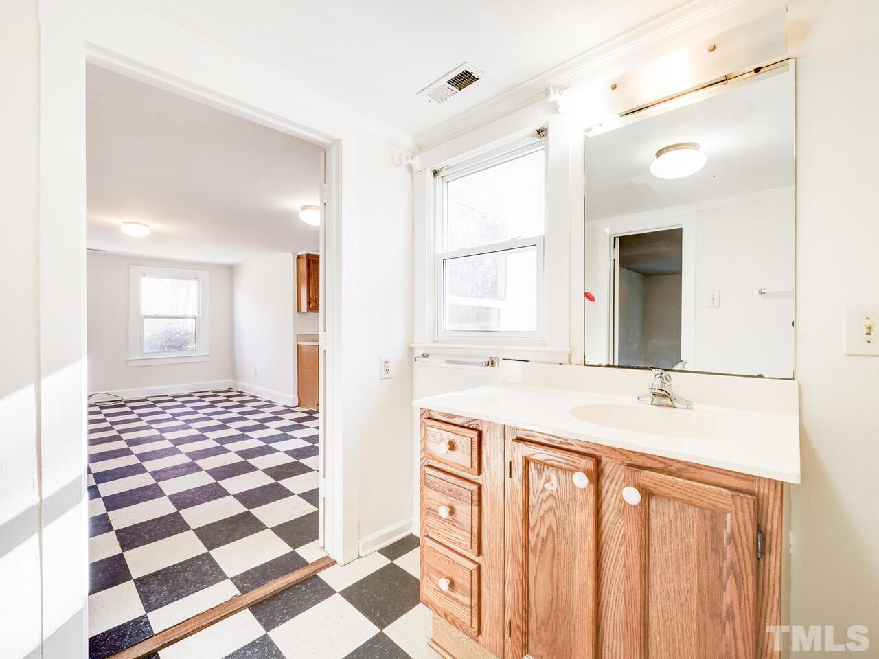 269 Hesters Store Road Roxboro, NC 27574 - Photo 18 of 30 a bathroom with a sink a mirror and a shower