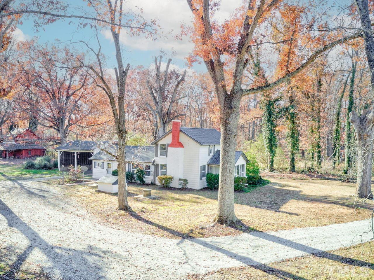 269 Hesters Store Road Roxboro, NC 27574 - Photo 30 of 30 a view of a white house with a road and trees