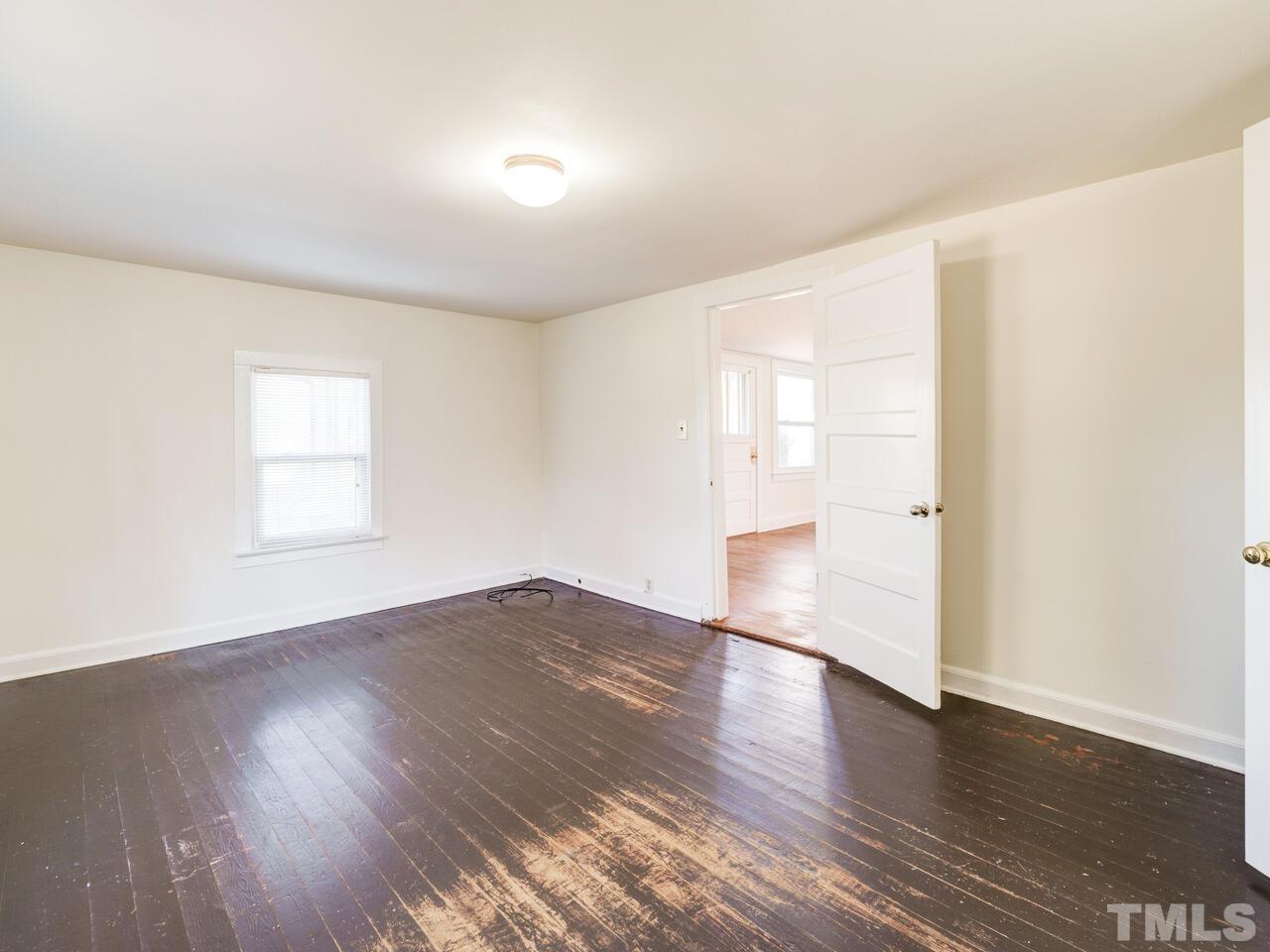 269 Hesters Store Road Roxboro, NC 27574 - Photo 4 of 30 an empty room with wooden floor and windows
