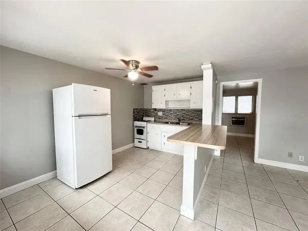 a kitchen with a refrigerator a stove top oven and a kitchen island