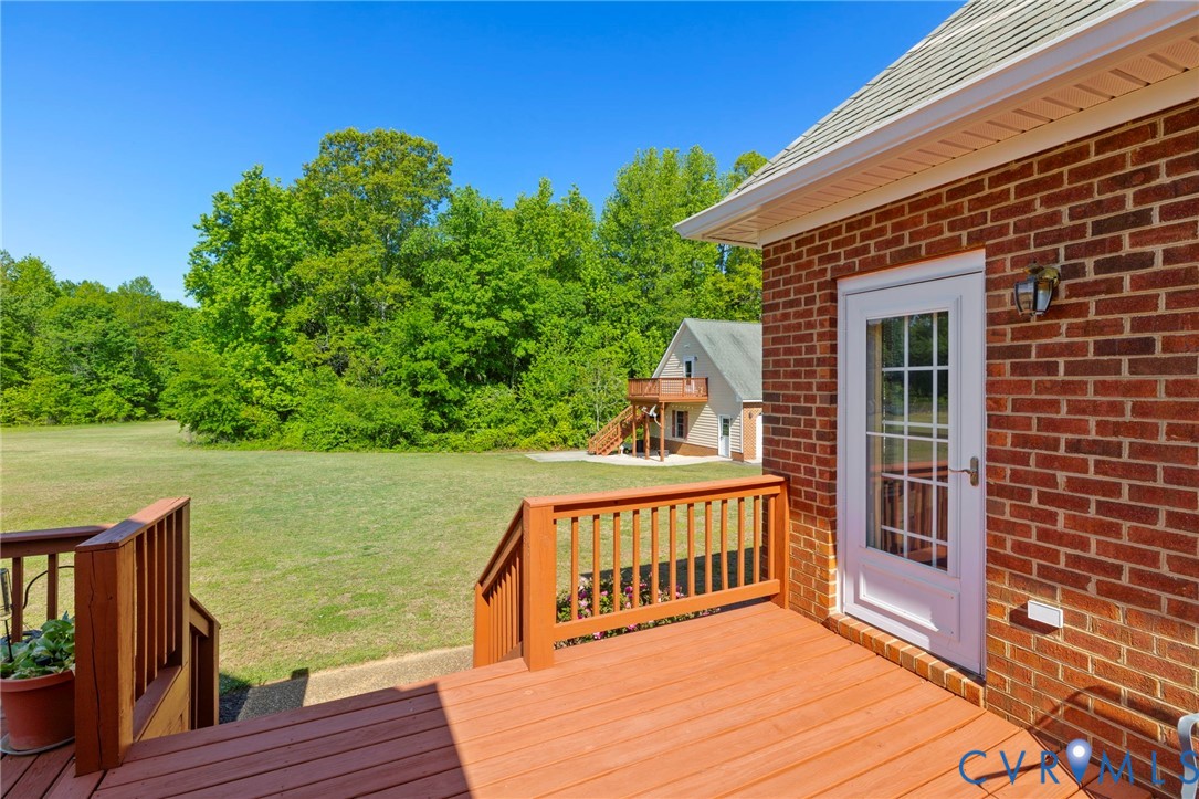 15441 Goshen Road Montpelier, VA 23192 - Photo 33 of 47 a view of a deck with wooden floor and fence next to a yard