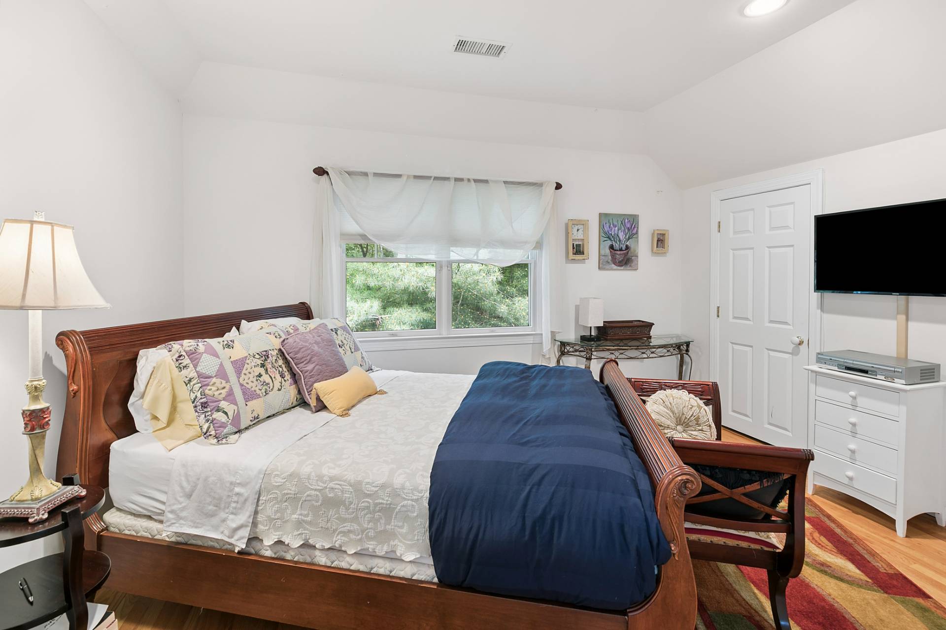 1557 Millstone Road Sag Harbor, NY 11963 - Photo 9 of 12 a bedroom with a bed and a flat screen tv