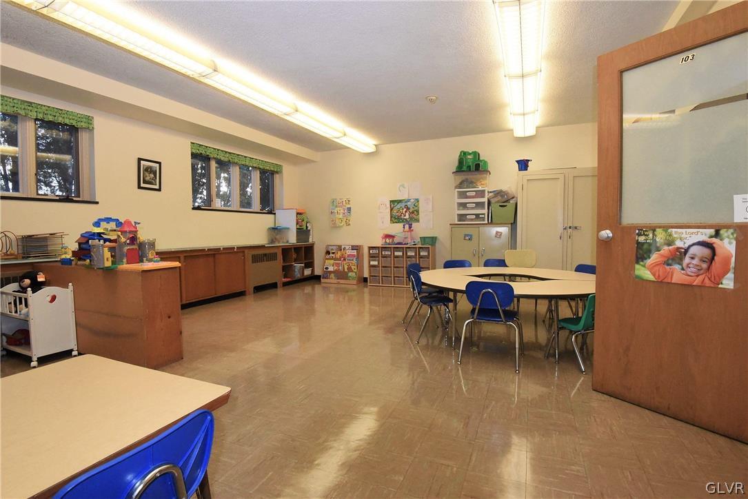 616 4th Bethlehem, PA 18015 - Photo 23 of 50 a living room with furniture and a dining table with wooden floor