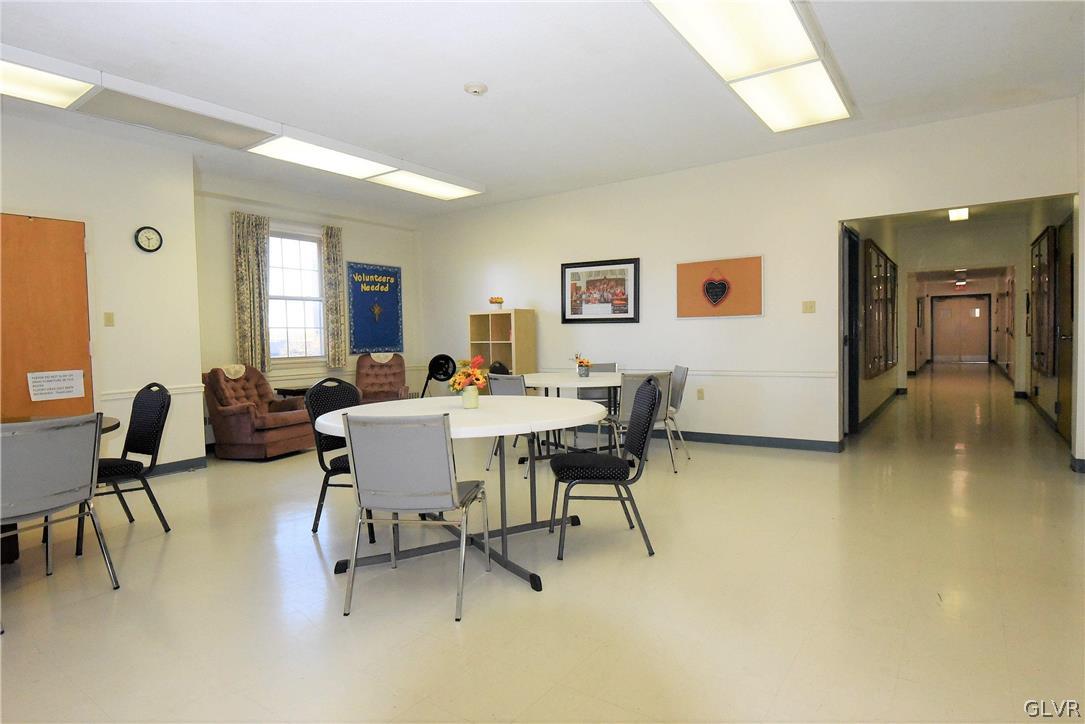 616 4th Bethlehem, PA 18015 - Photo 30 of 50 a living room with furniture and a dining table with chair next to a window