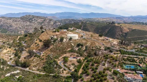 a view of a town with mountains in the background