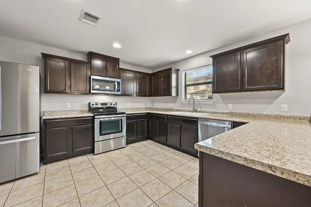 a kitchen with a sink stove and refrigerator