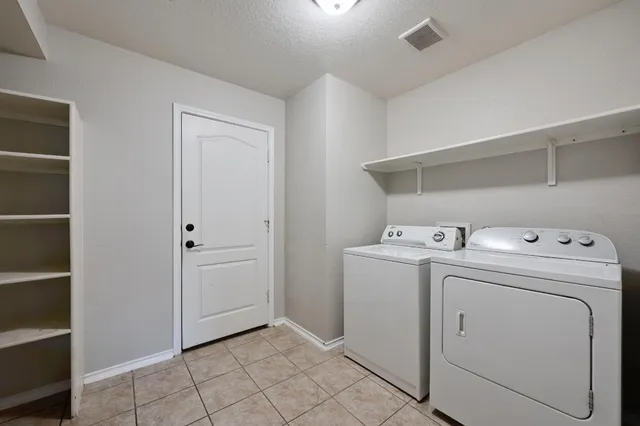 a view of storage and utility room with washer and dryer