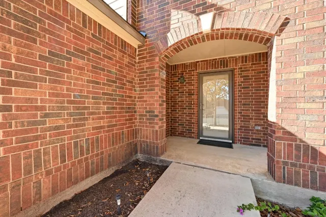 a view of a brick house with many windows