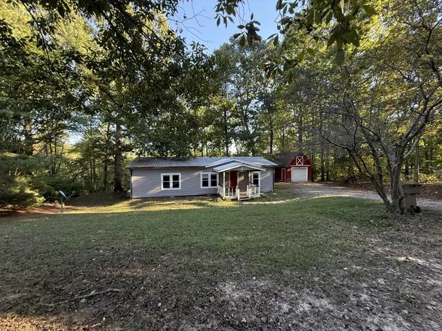 a house that has a tree in front of it